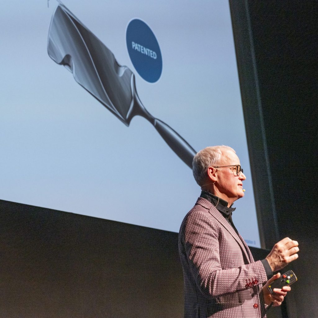 Frank Brornan presenting the calligraphy pen on stage