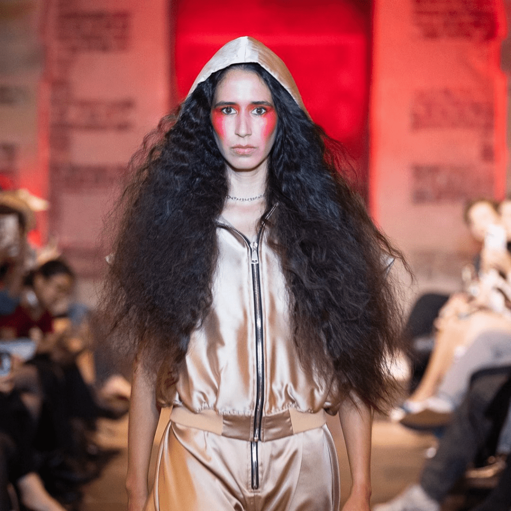 Model on runway with long frizzy hair